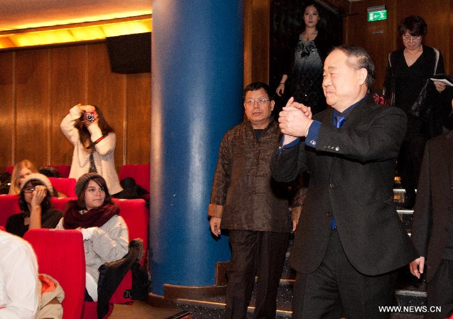 Chinese writer and 2012 Nobel Literature Prize winner Mo Yan (front R) greets college students who come to see the film Red Sorghum based on Mo Yan's manuscript in Stockholm, capital of Sweden on Dec. 9, 2012. (Xinhua/Liu Yinan) 