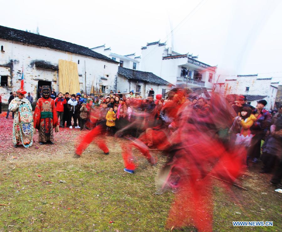 File photo taken on Jan. 24, 2012 shows Nuo dance artists give performance in Changjing Village of Wuyuan County, east China's Jiangxi Province. (Xinhua/Zhang Weiguo)