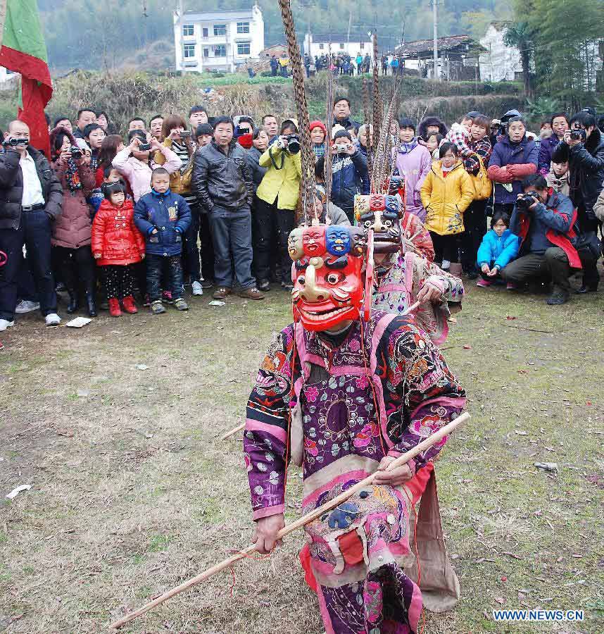 File photo taken on Jan. 24, 2012 shows Nuo dance artists giving performance in Changjing Village of Wuyuan County, east China's Jiangxi Province. (Xinhua/Zhang Weiguo)