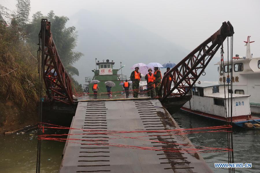 The flat-bottomed cargo boat Shun Feng, which capsized on Dec. 9, 2012, is anchored in Pingkou Town of Anhua County, central China's Hunan Province, Dec. 10, 2012. One person has been confirmed dead and seven others are still missing after the cargo boat capsized in waters near Pingshan Village of Pingkou Town early Sunday morning. (Xinhua/Guo Guoquan) 
