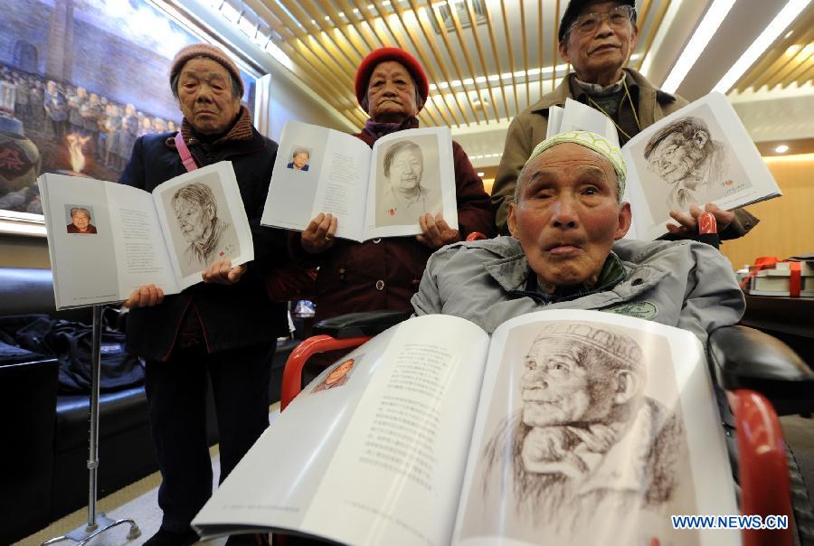 Nanjing Massacre survivor Chen Zhongyuan (R, front) and three other survivors show their portraits published in the new books at the Memorial Hall of the Victims in Nanjing Massacre in Nanjing, capital of east China's Jiangsu Province, Dec. 10, 2012. (Xinhua/Han Yuqing) 
