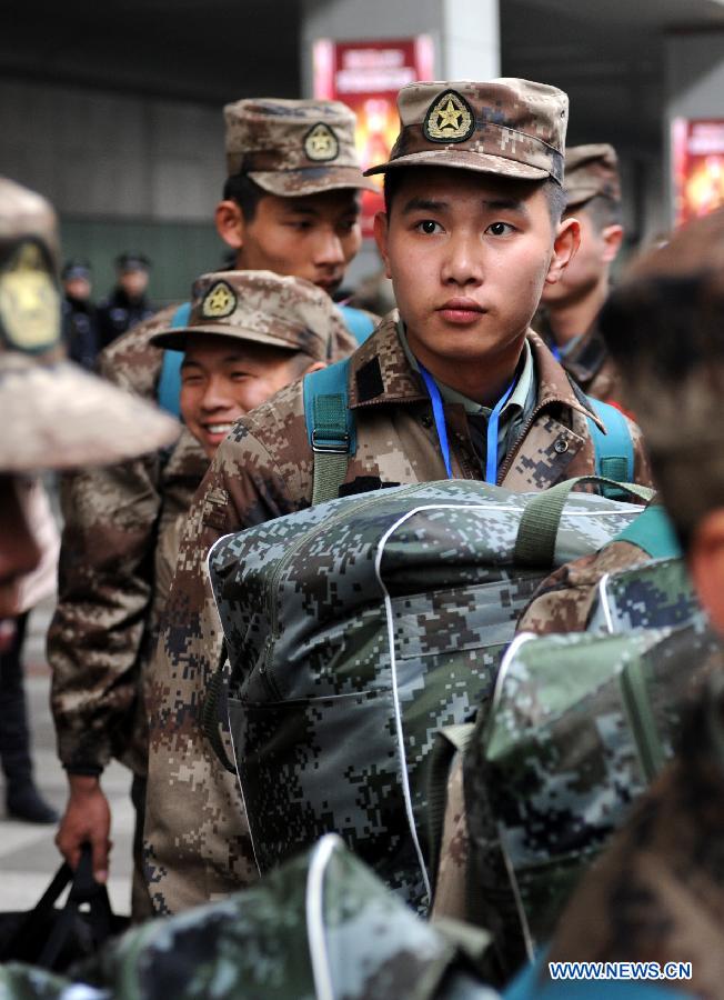 Newly recruited soldiers of People's Liberation Army (PLA) wait in line to get on a train at Nanjing Railway Station in Nanjing, capital of east China's Jiangsu Province, Dec. 10, 2012. A total of 545 new recruits from Nanjing, Nantong, Taizhou and Yancheng, four cities in Jiangsu, set off on Monday to join their army units. (Xinhua/Sun Can)