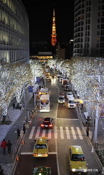 Vehicles pass through a street decorated by Christmas lights in Roppongi of Tokyo, capital of Japan, Dec. 10, 2012. (Xinhua/Kenichiro Seki)