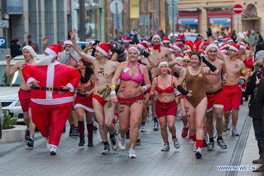 People take part in a half naked "Santa run" in Budapest, Hungary, Dec. 9, 2012. (Xinhua/Attila Volgyi) 