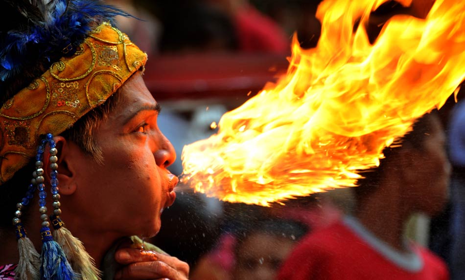 A man performs breath of fire at Chinatown in Manila, the Philippines on Jan 22, 2012, one day before the Chinese New Year. (AFP/Noel Celis)