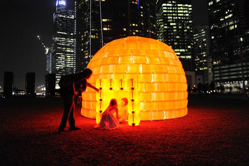 People experience a “tent-shaped” lighting art in Marina Bay, Singapore on Mar 9, 2012. (AFP/Simin Wang)
