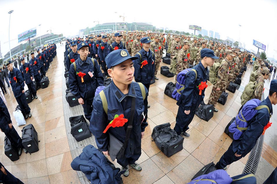 New recruits for the People's Liberation Army wait for the train to leave at a train station. The People's Liberation Army has launched its annual winter conscription this year. (Xinhua)