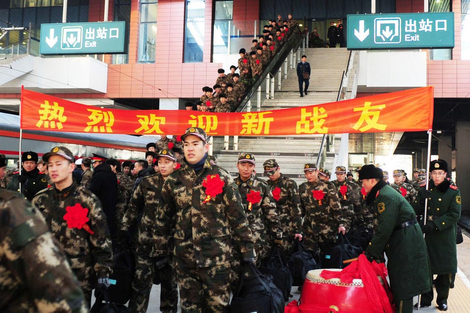 New recruits for the People's Liberation Army wait for the train to leave at a train station. The People's Liberation Army has launched its annual winter conscription this year. (Xinhua)