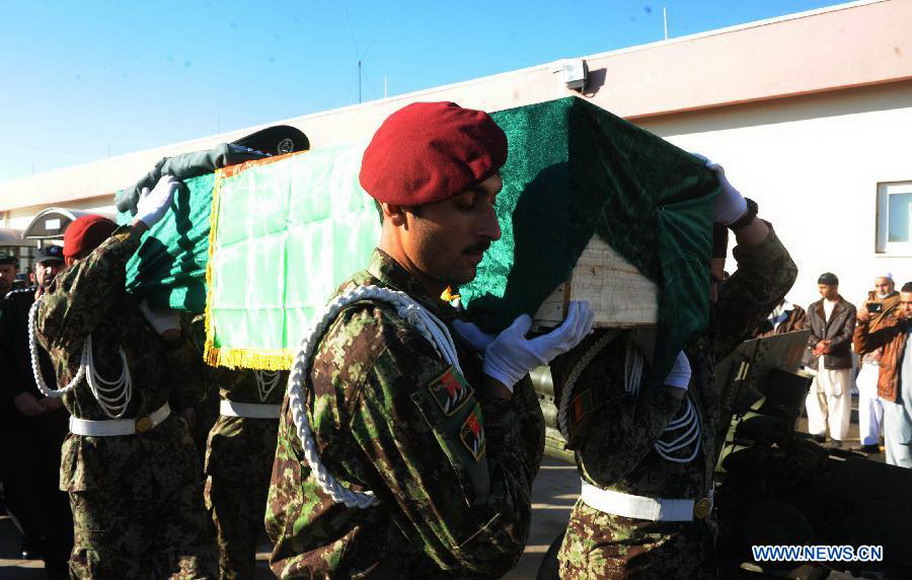 Afghan soldiers carry the coffin of Mohammad Musa Rasouli, the provincial police chief of Afghanistan's southwestern province of Nimroz, during his funeral in Herat province, west of Afghanistan, on Dec. 11, 2012. (Xinhua/Sardar) 