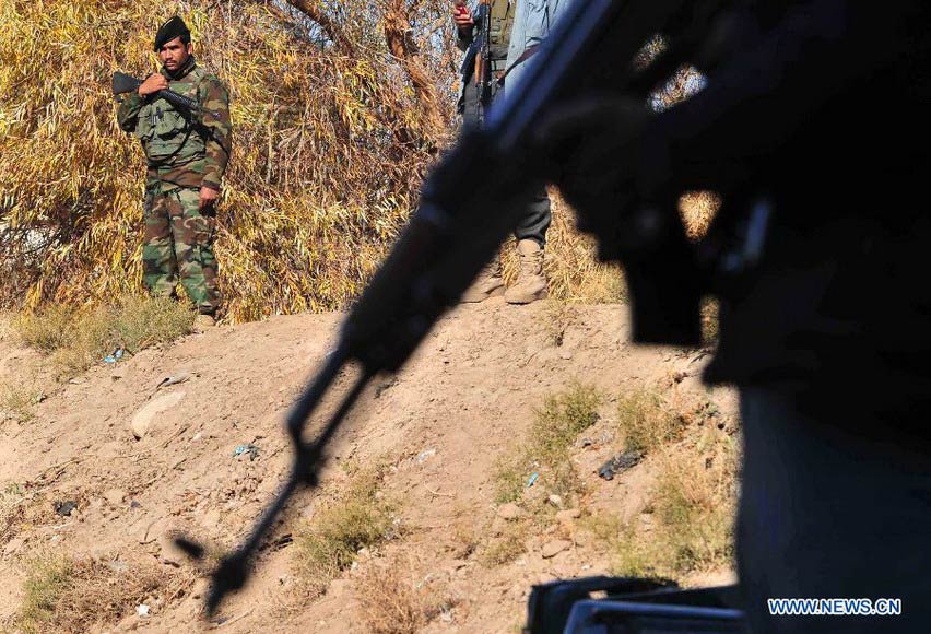 Afghan security officers stand guard during the funeral of Mohammad Musa Rasouli, the provincial police chief of Afghanistan's southwestern province of Nimroz, in Herat province, west of Afghanistan, on Dec. 11, 2012. Mohammad Musa Rasouli was killed Monday in a blast in neighboring Herat province. (Xinhua/Sardar) 