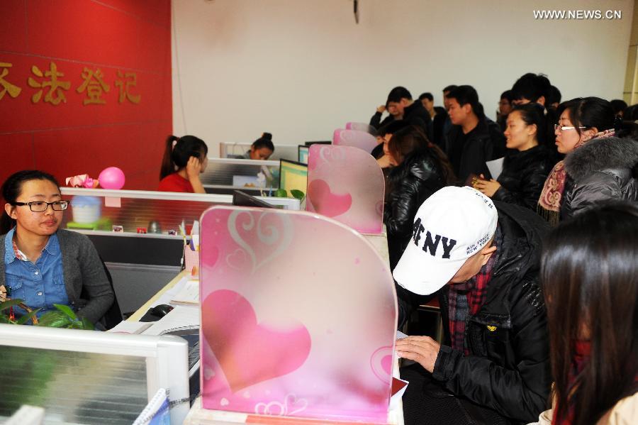 Couples wait to register for marriage in Changchun, capital of northeast China's Jilin Province, Dec. 12, 2012. Young couples across the country rushed to get married on Dec, 12, 2012, or 12/12/12, hoping that the "triple 12 day" will bring them good luck. In Chinese, the number 12 is pronounced like "Yao Ai", meaning "To Love" in English. (Xinhua/Lin Hong)