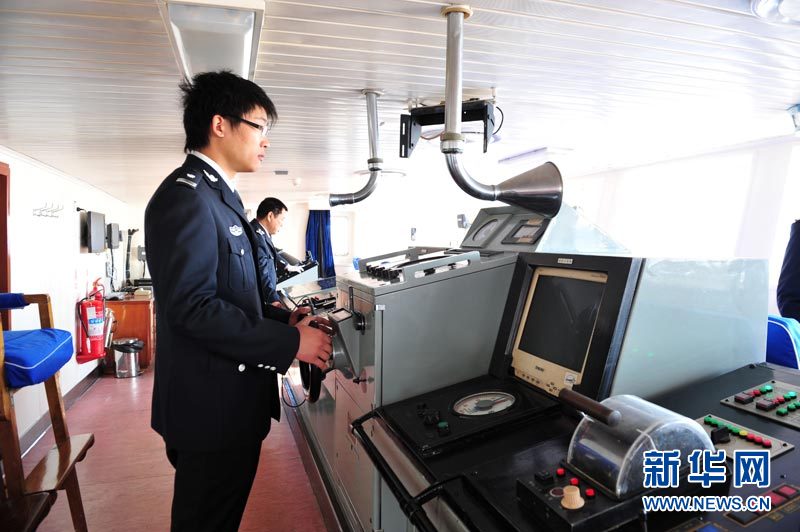 Sailor Zhang Lixiang steers the Chinese fishery patrol ship "Yuzheng 206" in east China's Shanghai, Dec. 11, 2012. The 5,800-tonne ship was sent to the East China Sea on its maiden voyage on Tuesday to protect the fishing activity. (Xinhua/Zhang Jiansong)