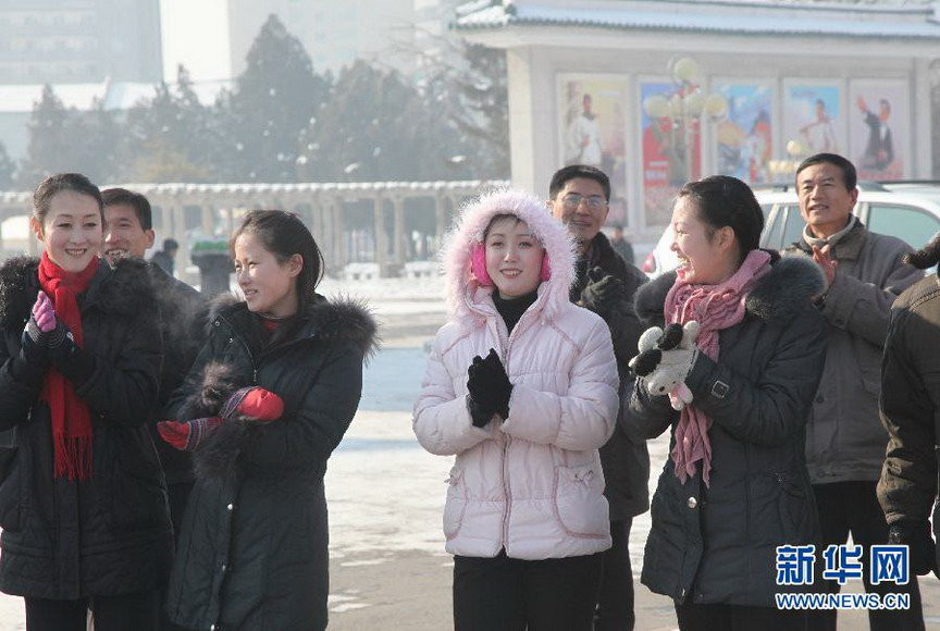 Citizens watch actors in traditional costumes celebrating DPRK’s successful rocket launch in front of Pyongyang Grand Theater on Dec 12, 2012. Celebrations were held in Pyongyang after the country successfully launched a Kwangmyongsong-3 satellite on Wednesday. (Xinhua/ Zeng Tao) 