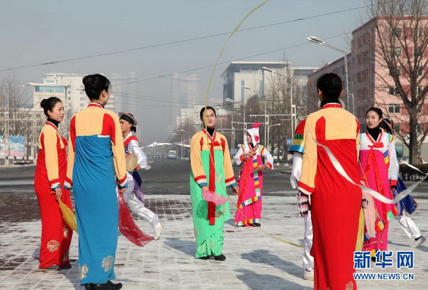 People in traditional costumes celebrate the successful launch of the long-range rocket in Pyongyang on Dec 12, 2012. Celebrations were held in the street of Pyongyang after the country successfully launched a Kwangmyongsong-3 satellite on Wednesday. (Xinhua/ Zeng Tao)