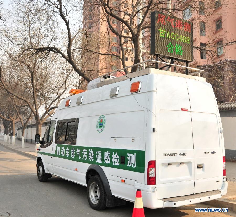 A vehicle with the remote emission test system parks at the roadside in Lanzhou, capital of northwest China's Gansu Province, Dec. 12, 2012. Two vehicles with the test system have been put into operation in Lanzhou recently. The system could collet and analyse emission data from a vehicle and record the vehicle number through a remote sensoring equipment without interrupting the traffic. (Xinhua/Huang Wenxin)