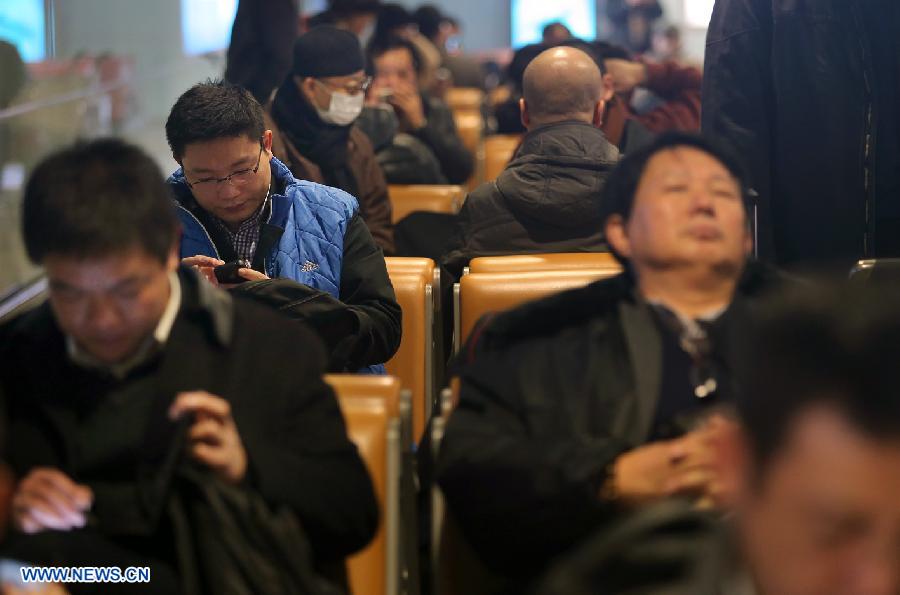 Passengers wait for flights at Beijing Capital International Airport in Beijing, capital of China, Dec. 12, 2012. A snow that hit China's capital city on Wednesday has led to massive flight delays at Beijing Capital International Airport. (Xinhua/Wan Xiang)