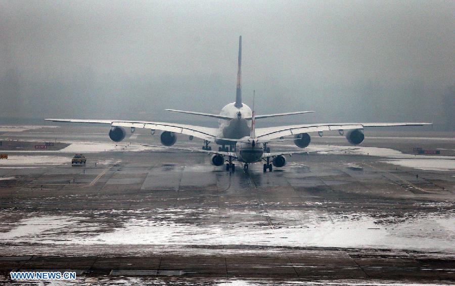 Passenger planes wait for take-off signal at Beijing Capital International Airport in Beijing, capital of China, Dec. 12, 2012. A snow that hit China's capital city on Wednesday has led to massive flight delays at Beijing Capital International Airport. (Xinhua/Wan Xiang) 