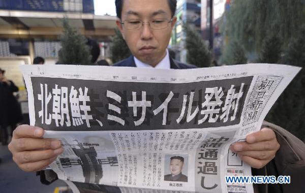 A man reads an extra of Asahi Shimbun with reports about the rocket launch by the Democratic People's Republic of Korea (DPRK), in Tokyo, Japan, Dec. 12, 2012. The DPRK on Wednesday successfully launched and orbited a Kwangmyongsong-3 satellite, the official news agency KCNA reported. (Xinhua/Kenichiro Seki)