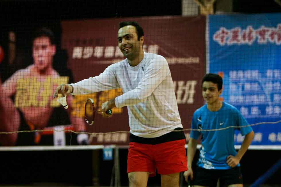 Peyam (Front) and his son Bai Yun play badminton with friends in Yinchuan, capital of northwest China's Ningxia Hui Autonomous Region, March 16, 2012. (Xinhua/Zheng Huansong)
