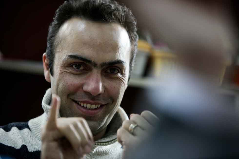 Peyam, president of Smile English School, reacts during a discussion on teaching with teachers at his school in Yinchuan, capital of northwest China's Ningxia Hui Autonomous Region, March 15, 2012.(Xinhua/Zheng Huansong)