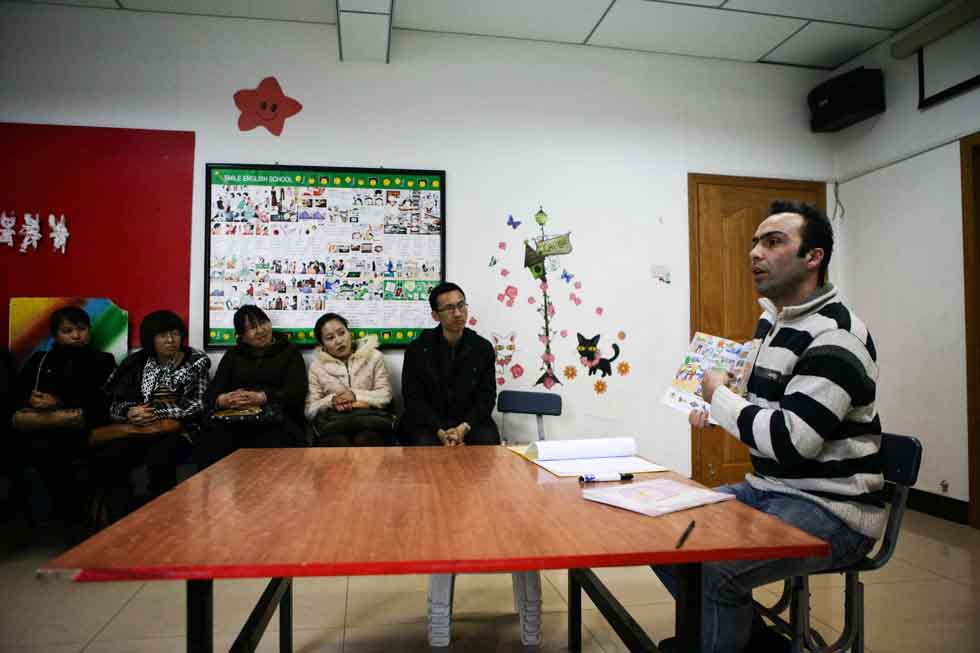 Peyam (1st R), president of Smile English School, holds a parents meeting at his school in Yinchuan, capital of northwest China's Ningxia Hui Autonomous Region, March 16, 2012.(Xinhua/Zheng Huansong)