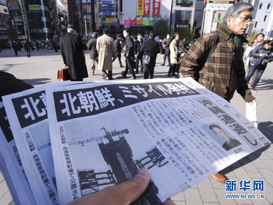 A staff member of the Asahi Shimbun delivers the extra of the newspaper with reports about the rocket launch by the Democratic People's Republic of Korea (DPRK), in Tokyo, Japan, Dec. 12, 2012. The DPRK on Wednesday successfully launched and orbited a Kwangmyongsong-3 satellite, the official news agency KCNA reported. (Xinhua/Kenichiro Seki)