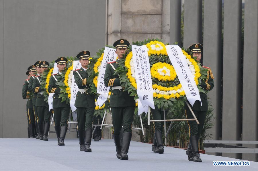 Soldiers present wreaths during a memorial ceremony at the Memorial Hall of the Victims in Nanjing Massacre by Japanese Invaders in Nanjing, capital of east China's Jiangsu Province, Dec. 13, 2012, to mark the 75th anniversary of the Nanjing Massacre.(Xinhua/Shen Peng)