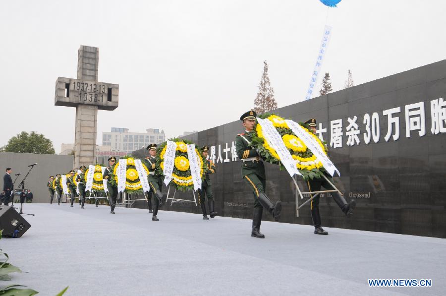 Soldiers present wreaths during a memorial ceremony at the Memorial Hall of the Victims in Nanjing Massacre by Japanese Invaders in Nanjing, capital of east China's Jiangsu Province, Dec. 13, 2012, to mark the 75th anniversary of the Nanjing Massacre.(Xinhua/Shen Peng)