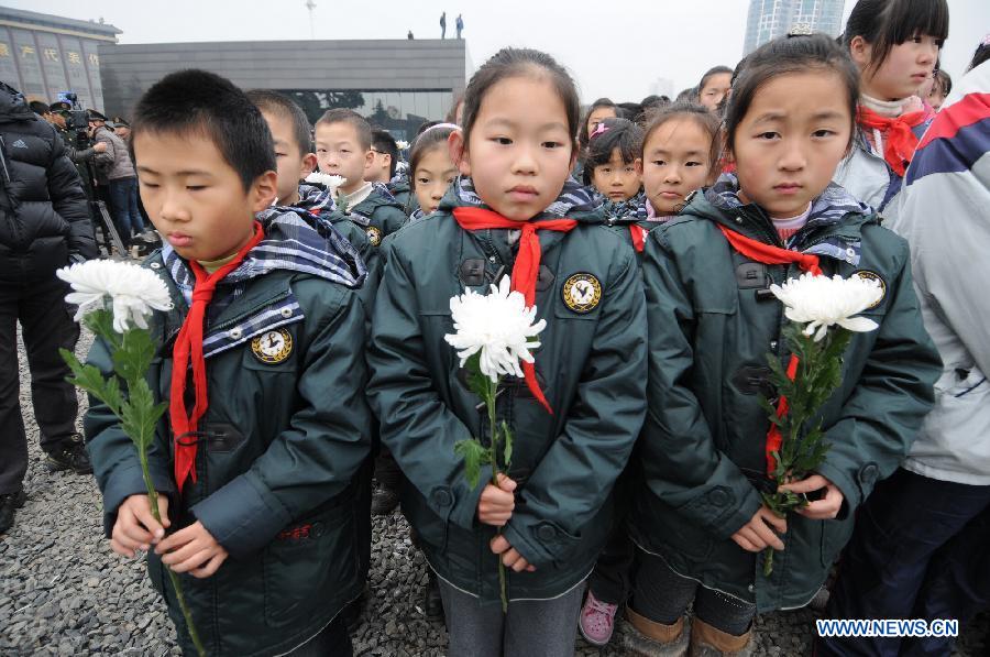 Children attend a memorial ceremony at the Memorial Hall of the Victims in Nanjing Massacre by Japanese Invaders in Nanjing, capital of east China's Jiangsu Province, Dec. 13, 2012, to mark the 75th anniversary of the Nanjing Massacre.(Xinhua/Shen Peng) 