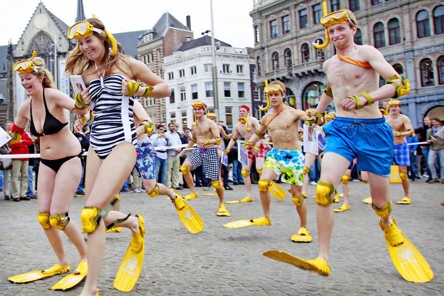 People in swimming flippers run in a competition at Dam Square of Amsterdam, Holland on May 9, 2012. (AFP/ Anp Ade Johnson)