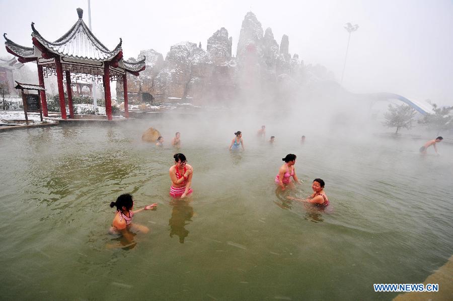 People soak in the hotspring in Xingtai, north China's Hebei Province, Dec. 13, 2012. Local people went to hotspring during snowy days. (Xinhua/Chen Lei)