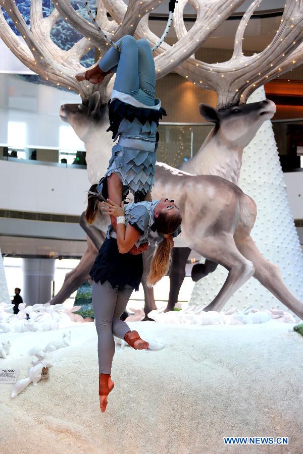 Australian performers perform stunt skills at the International Finance Center Mall in Hong Kong, south China, Dec. 13, 2012. A group of Autralian actors and actresses were invited to present 30 shows which combined stunts and dances in the mall from Thursday until Dec. 26, 2012. (Xinhua/Li Peng)