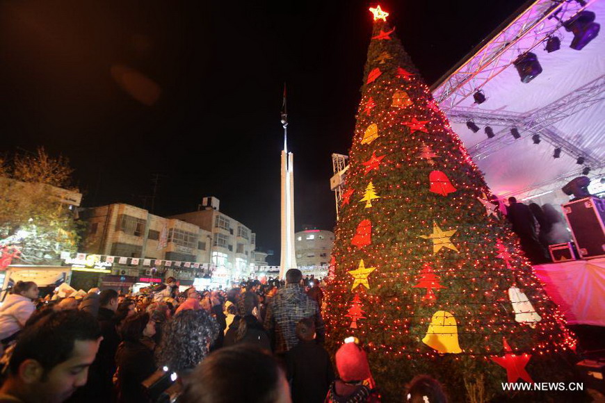 A celebration is held by Palestinians to inaugurate Christmas' decorations in the West Bank city of Ramallah, on Dec. 12, 2012. (Xinhua/Fadi Arouri) 