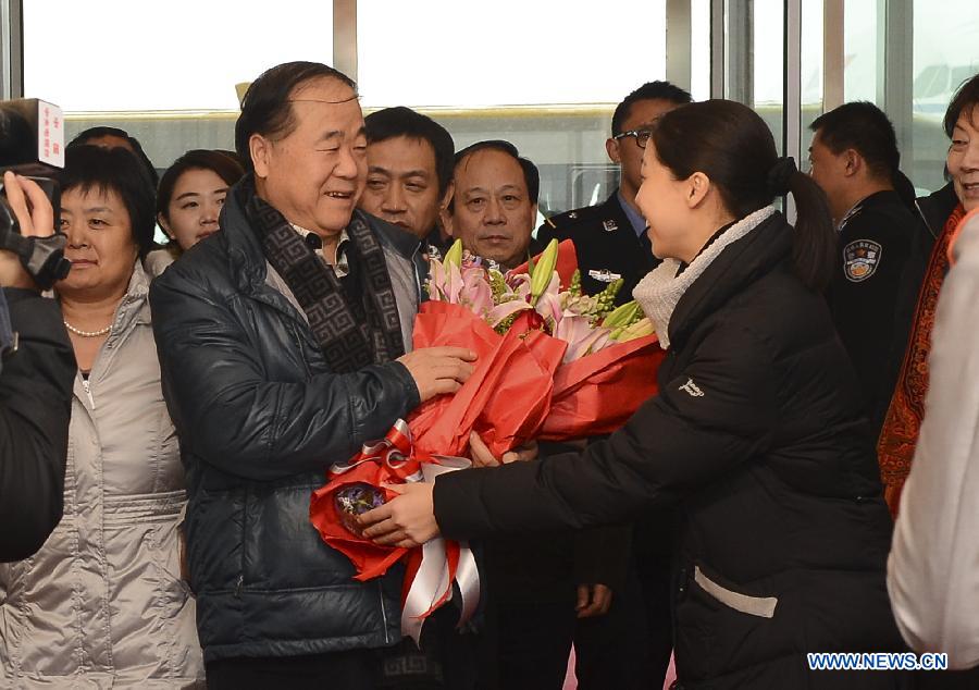Winner of the 2012 Nobel Prize for Literature, Chinese writer Mo Yan (L, front), is welcomed at the Beijing Capital International Airport in Beijing, capital of China, Dec. 14, 2012. Mo Yan returned to Beijing on Friday after receiving Nobel Prize in Literature at the 2012 Nobel Prize ceremony in Stockholm, Sweden. (Xinhua/Jin Liangkuai)