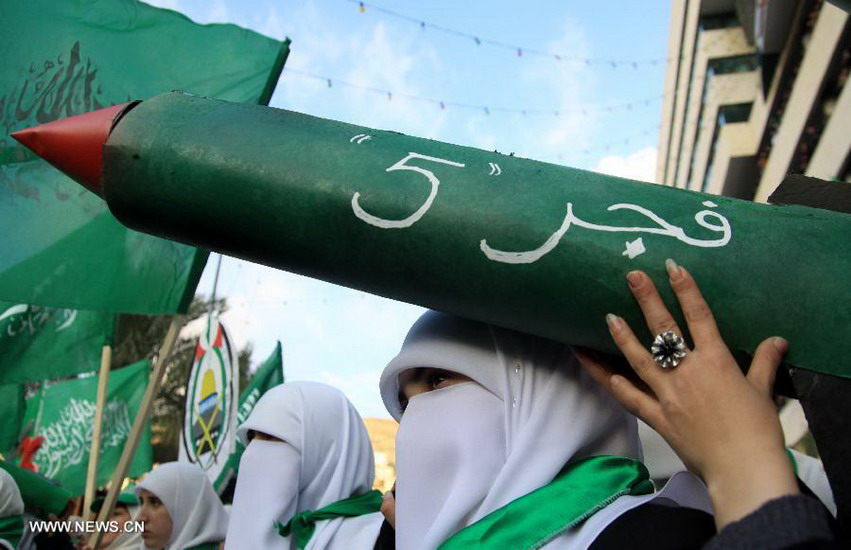 Palestinian Hamas supporters hold a carton rocket as they take part in a rally marking the 25th anniversary of the Islamic movement, in the West Bank city of Nablus on Dec. 13, 2012. (Xinhua/Ayman Nobani)