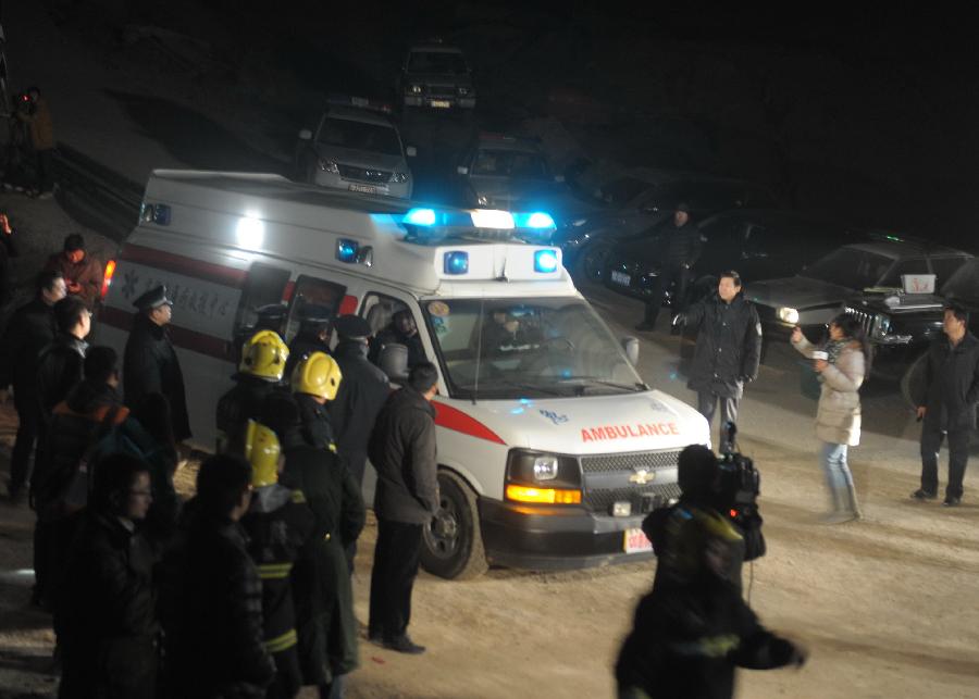 An ambulance with survived workers leaves a railway tunnel in Lanzhou, capital of northwest China's Gansu Province, Dec. 14, 2012. Five construction workers who were buried in a tunnel that was under construction around 2:50 p.m. on Wednesday were rescued at 10:07 p.m. Friday. (Xinhua/Nie Jianjiang) 