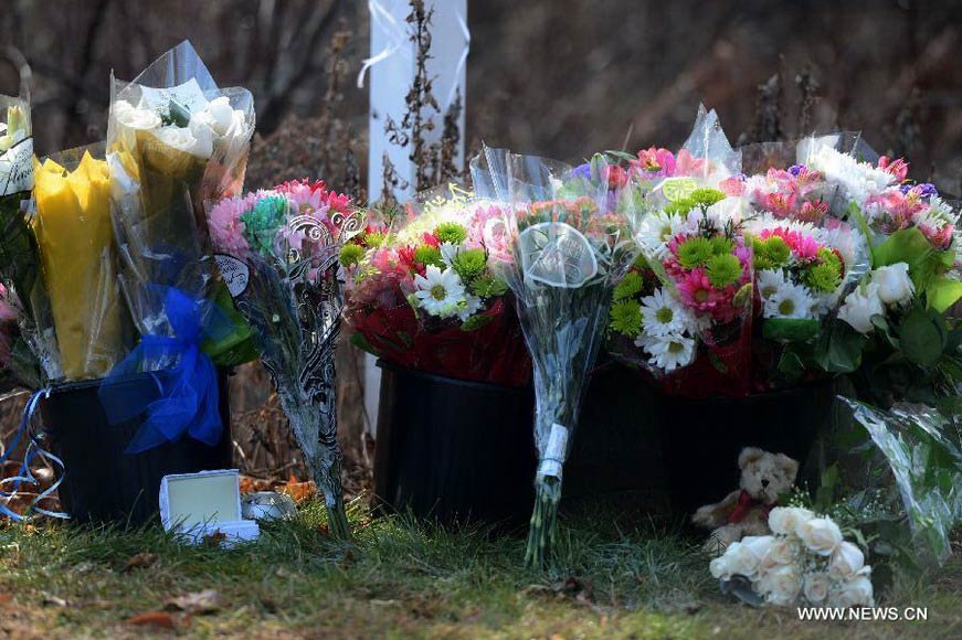 Flowers and toys are seen near Sandy Hook Elementary School, where a gunman opened fire on school children and staff in Newtown, Connecticut, Dec. 15, 2012. A shooting incident on Friday morning in the elementary school in Newtown of the Connecticut State of the United States killed at least 28 people, including 20 children. (Xinhua/Wang Lei) 