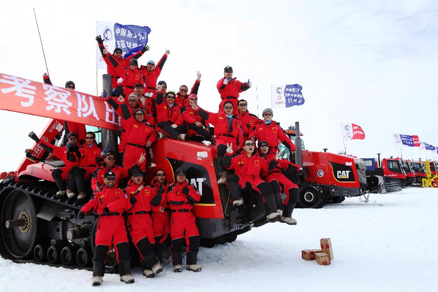 Members of Chinese Antarctic exploration team pose for group photos in Antarctic on Dec. 16, 2012, before leaving for China's Kunlun station. The journey is the country's 29th scientific expedition to Antarctica. A significant part of the mission will also include looking for a location for the country's fourth station in the region and second-phase construction of the Kunlun Station. (Xinhua/Xu Wei)