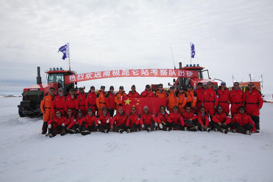 Members of Chinese Antarctic exploration team pose for group photos in Antarctic on Dec. 16, 2012, before leaving for China's Kunlun station. The journey is the country's 29th scientific expedition to Antarctica. A significant part of the mission will also include looking for a location for the country's fourth station in the region and second-phase construction of the Kunlun Station. (Xinhua/Xu Wei)