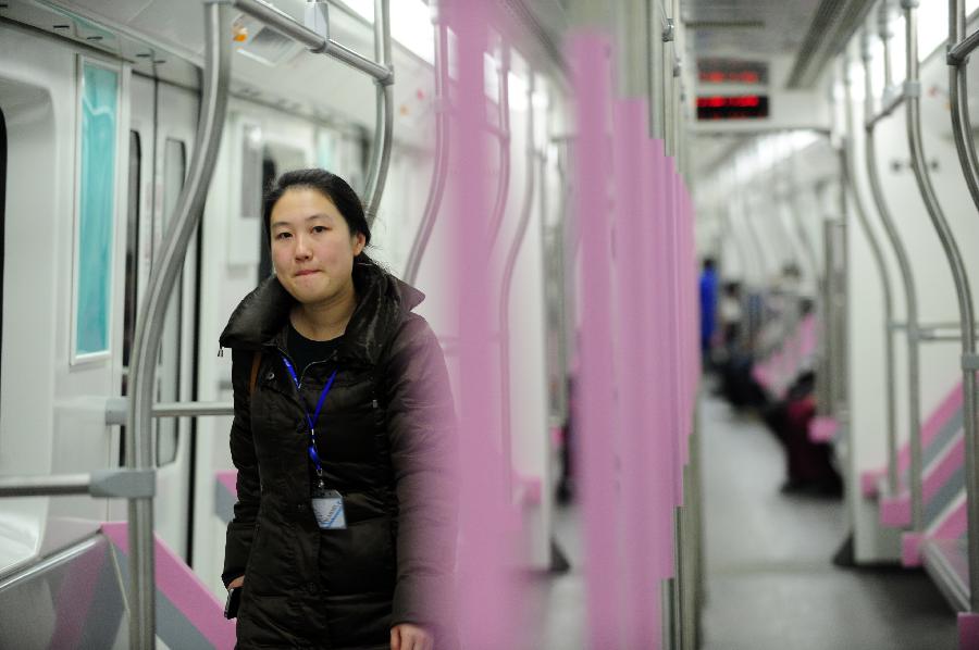 A staff member inspects the train of Wuhan Subway Line No.2 in Wuhan, capital of central China's Hubei Province, Dec. 14, 2012. Subway Line No.2 is the first subway line of the city, also the first subway line across the Yangtze River. The construction of the project started in 2006. It is expected to be put into trial operation on Dec. 28. (Xinhua/Hao Tongqian) 