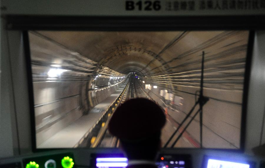 A train of Wuhan Subway Line No.2 moves in the tunnel in Wuhan, capital of central China's Hubei Province, Dec. 14, 2012. Subway Line No.2 is the first subway line of the city, also the first subway line across the Yangtze River. The construction of the project started in 2006. It is expected to be put into trial operation on Dec. 28. (Xinhua/Hao Tongqian) 