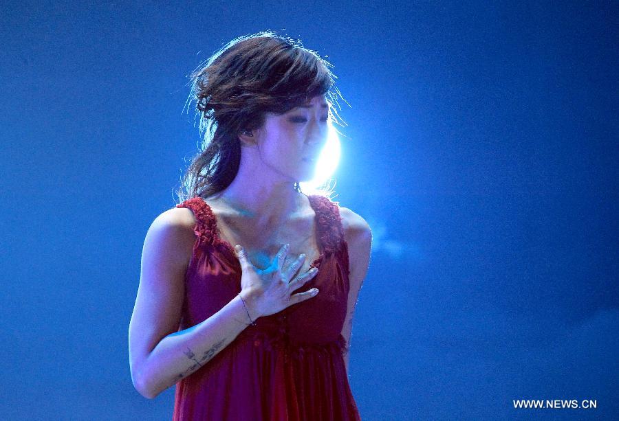 Singer Sandy Lam performs during her concert in Hangzhou, capital of east China's Zhejiang Province, Dec. 15, 2012. (Xinhua/Wu Huang)  