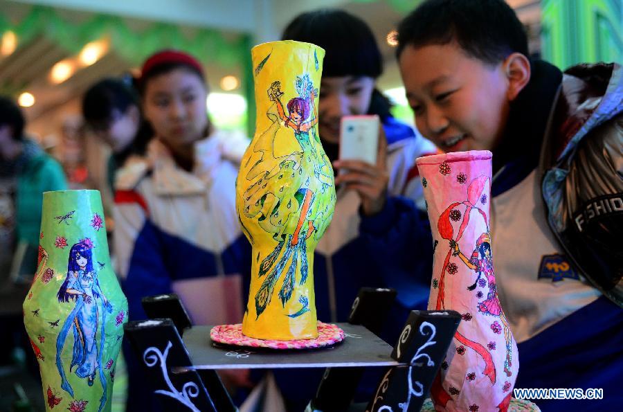 Students view handicrafts made of wastes and scraps during an exhibition in Lanzhou, capital of northwest China's Gansu province, Dec. 14, 2012. A ten-day show themed on environmental protection opened here on Friday, during which over 1,800 artworks made by local primary and middle school students are displayed. (Xinhua/Zhang Meng) 