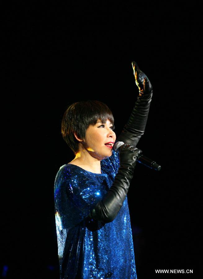 Singer Tiger Wong performs during her concert in Nanjing, capital of east China's Jiangsu Province, Dec. 15, 2012. (Xinhua/Yan Minhang) 
