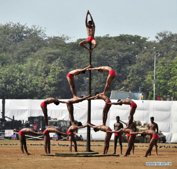 Indian soldiers perform during a military drill and arms exhibition at Shivaji park in Mumbai, India, on Dec. 15, 2012. A troop of Indian Defense Ministry held the military drill and arms exhibition here to raise the public awareness of Indian army and military affairs on Saturday. (Xinhua/Wang Ping) 