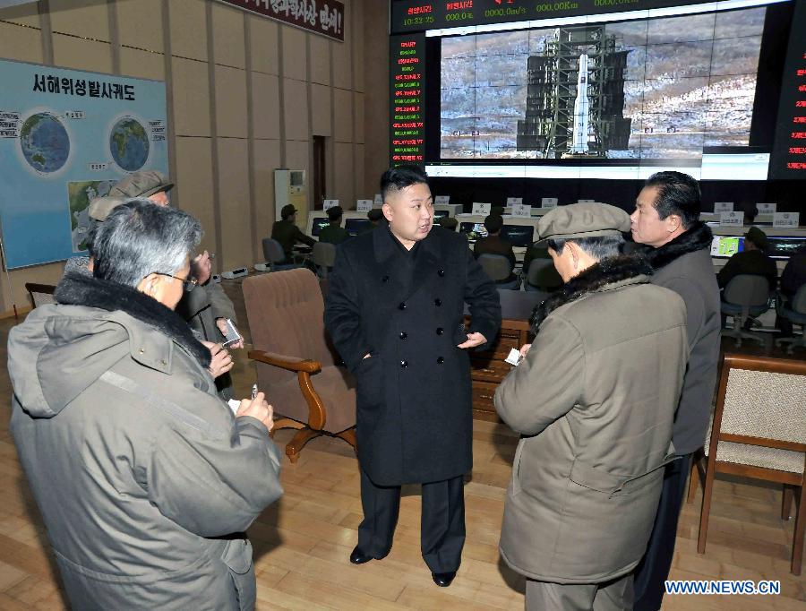 Photo released by Korean Central News Agency (KCNA) on Dec. 16, 2012 shows Kim Jong Un (C), top leader of the Democratic People's Republic of Korea (DPRK), congratulate recently on scientific workers of the second Kwangmyongsong-3 satellite launch project at Sohae Space Center in Cholsan County, North Phyongan Province, DPRK. (Xinhua/KCNA) 