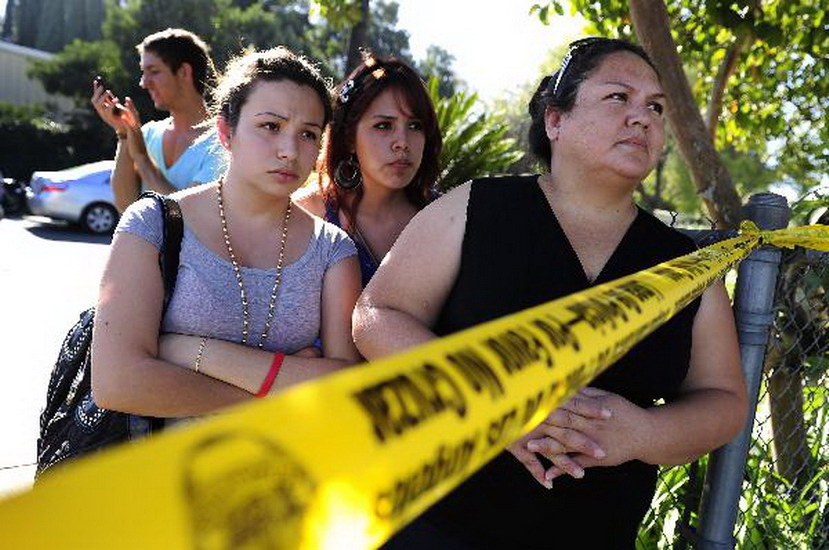 Families of the students wait outside the Gardena High School in Gardena, Calif., Tuesday, Jan. 18, 2011. Two students were wounded by gun shooting at the school. (Xinhua/AFP)