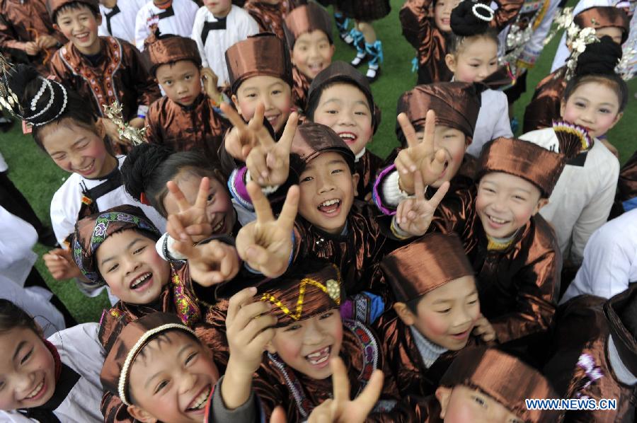 Children of the Dong ethnic group take part in the Sama Festival on a street in Rongjiang County, southwest China's Guizhou Province, Dec. 18, 2012. The Sama Festival, an ancient traditional festival commemorating the woman ancestors of the Dong ethnic group, was listed as one of China's state intangible cultural heritages in 2006. (Xinhua/Ou Dongqu) 