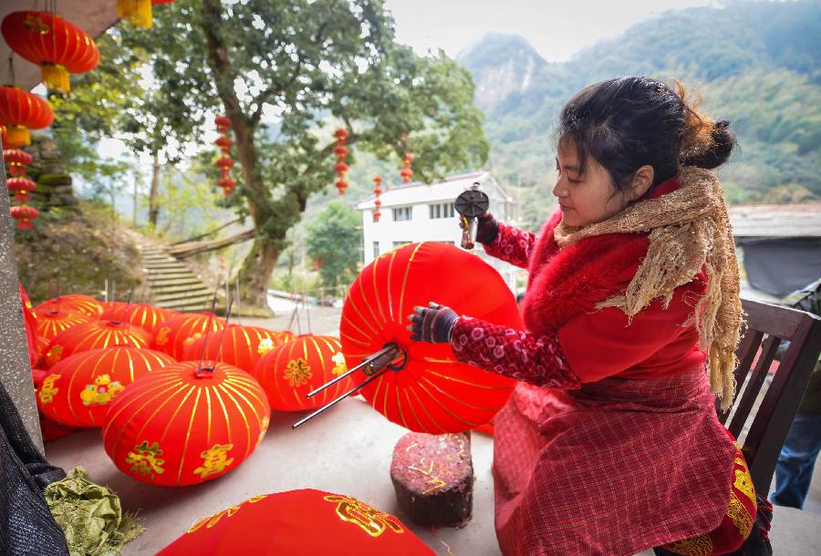 Villagers make Chinese lanterns in Yaxi Village of Xianju County, east China's Zhejiang Province, Dec. 18, 2012. As the Spring Festival approaches, workers in Yaxi Village are busy making lanterns, a traditional decoration for Spring Festival in China. (Xinhua/Xu Yu)