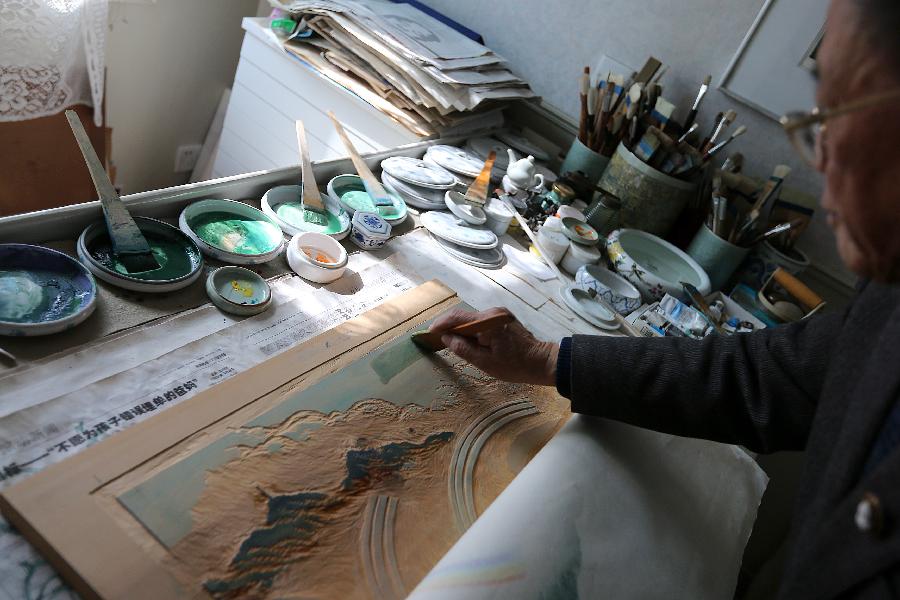 Chinese painter Lu Fang creates a woodblock painting at his studio in Hangzhou City, capital of east China's Zhejiang Province, Dec. 4, 2012. Lu Fang started to create woodblock paintings since 1950s, his works tend to depict the scenery of the West Lake in Hangzhou. The technique of woodblock printing was listed as a state intangbile cultural heritage of China in 2008. (Xinhua/Zhang Chuanqi) 